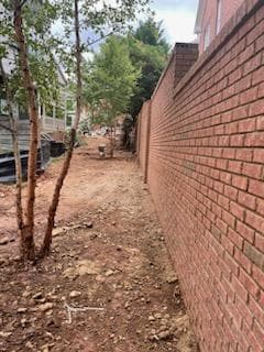 Strategic Home Division: Installing a Fresh Brick Wall for Enhanced Privacy and Distinctive Separation